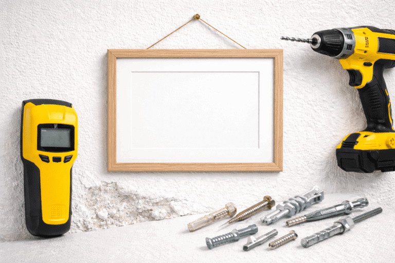 Tools for hanging on drywall with a drill, level, and anchors.