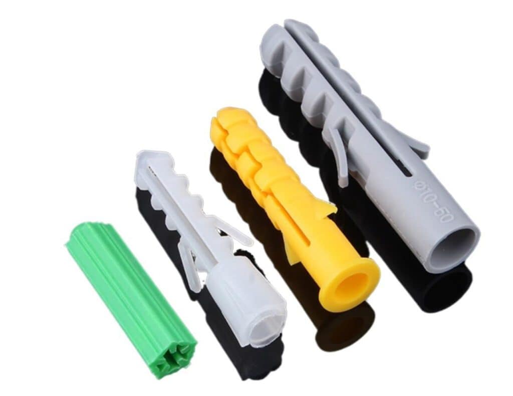 Assorted drywall anchors and tools for secure wall mounting.